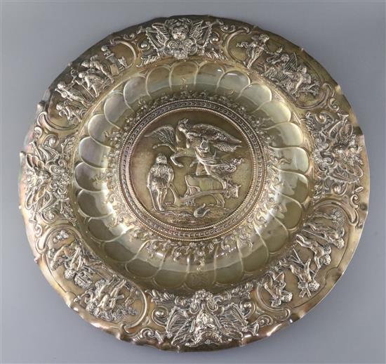 A large embossed white metal charger,